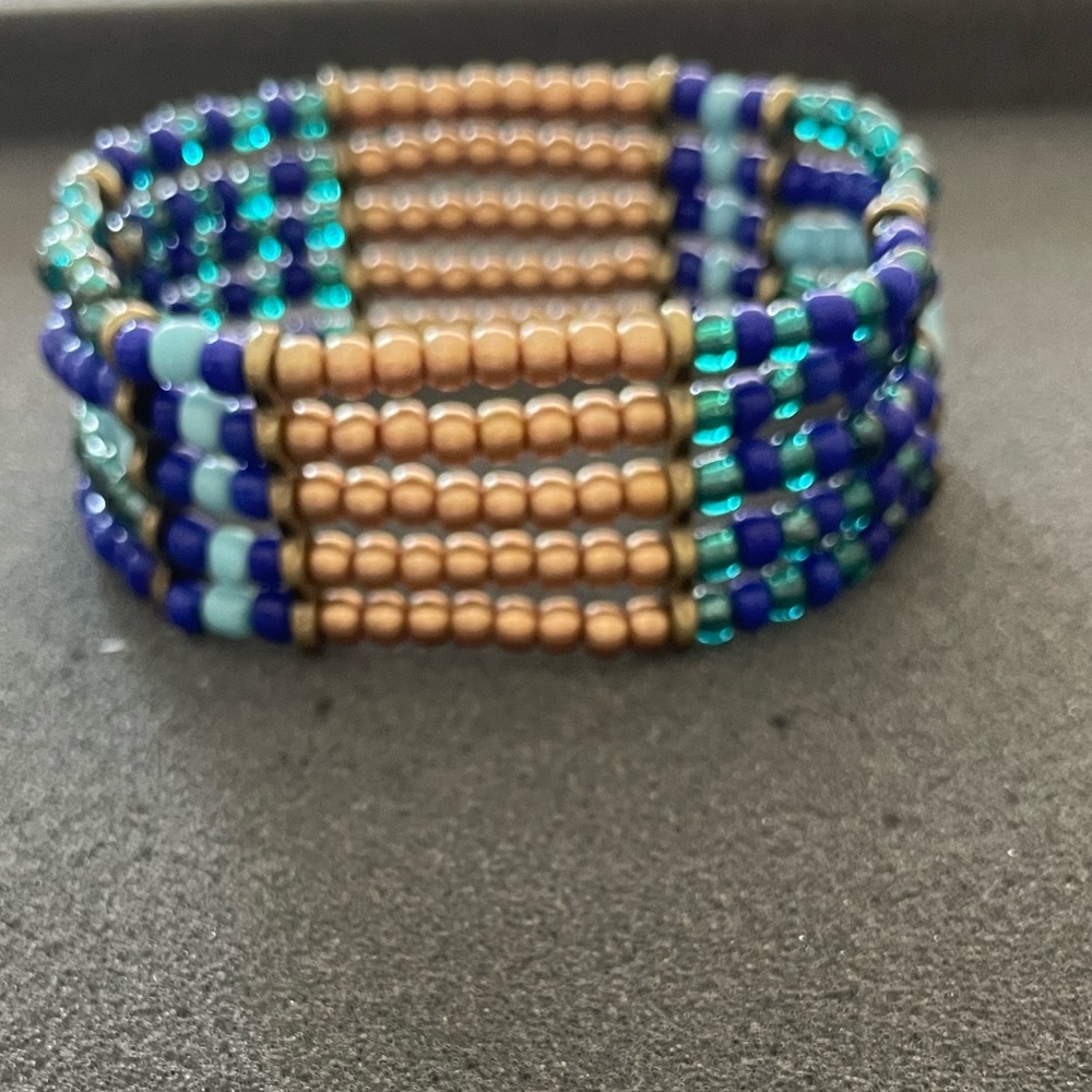 Light blue, dark blue, gold bracelet.